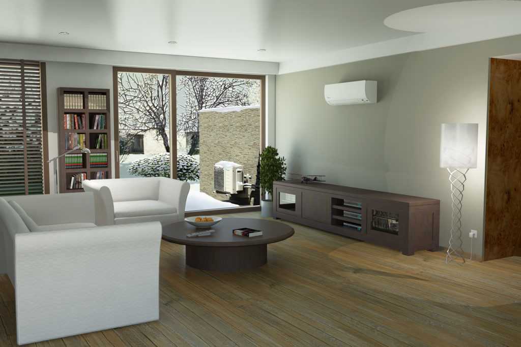 Modern living room featuring a ductless HVAC system, white furniture, wooden flooring, and large windows with a snowy outdoor view, emphasizing home comfort and climate control options in Phenix City, AL.