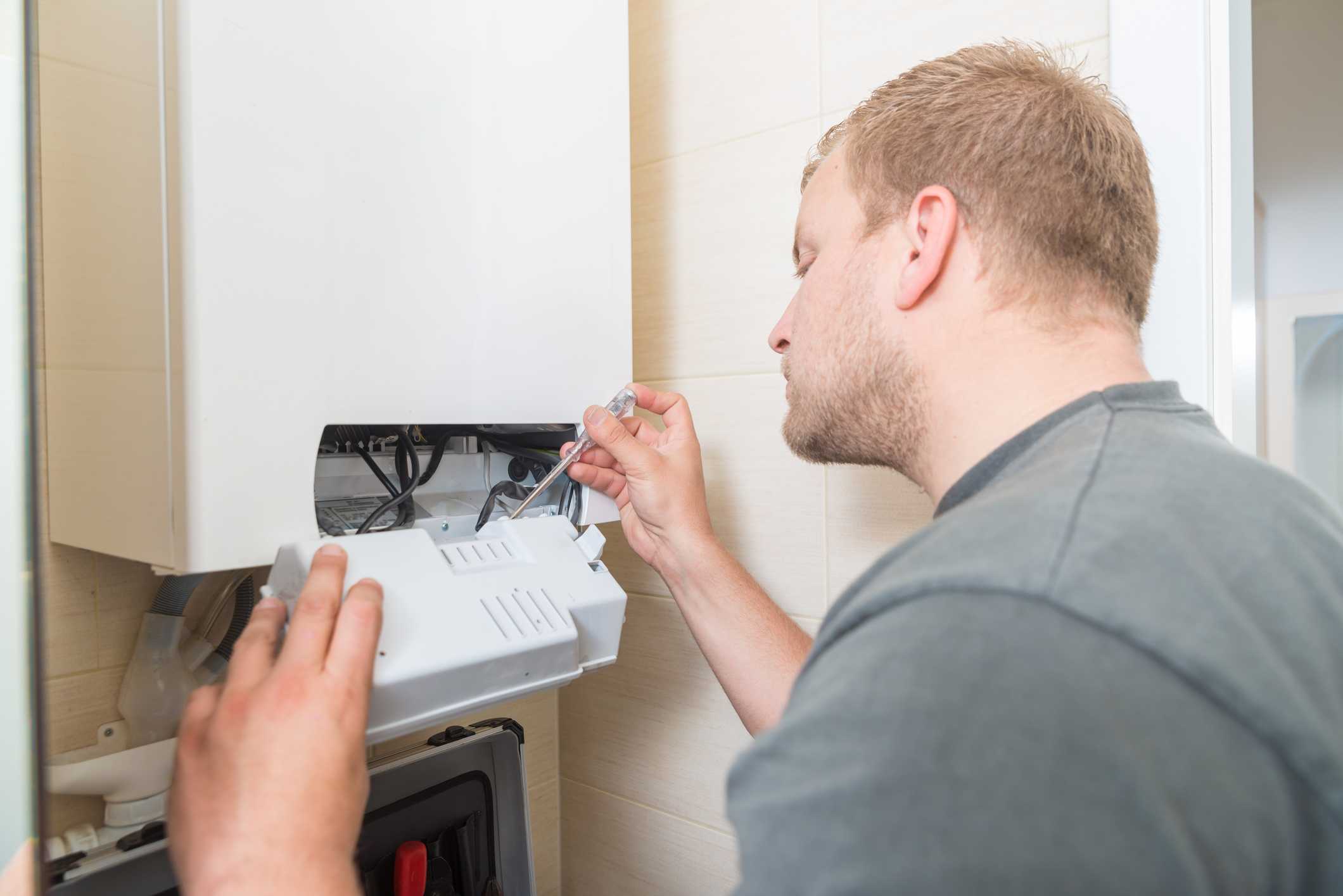 Technician installing a heating system, emphasizing professional heater installation services in Phenix City, AL.